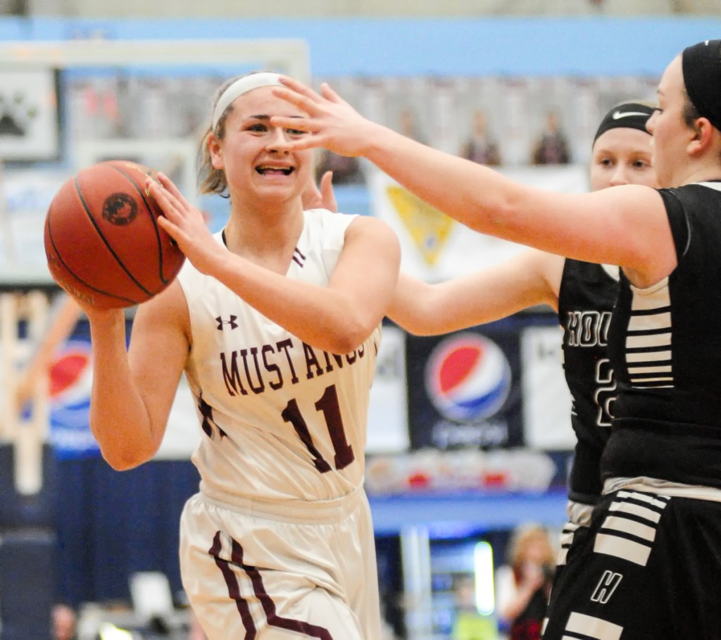 Staff photo by Joe Phelan 
 Monmouth's Hannah Anderson (11) looks for a teammate to pass to against Houlton in the Class C state championship game Saturday at the Augusta Civic Center.