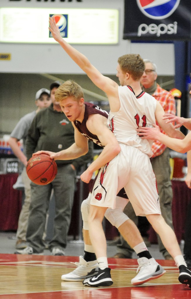 Staff photo by Joe Phelan
George Stevens Academy's Maxwell Mattson, left, tries to get around Hall-Dale's Dean Jackman in the Class C state championship basketball game Saturday at the Augusta Civic Center.