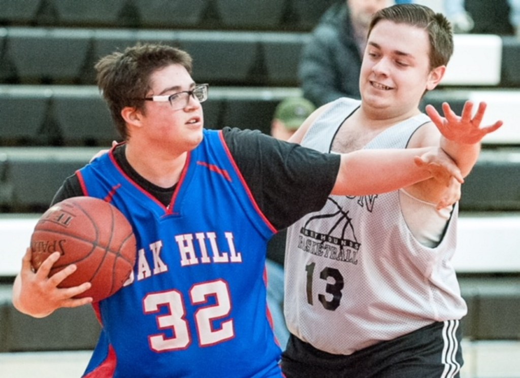 Lisbon's Dawson Martel, right, defends against Oak Hill's Tommy Grayson during the first half of Tuesday afternoon's Unified Basketball game in Lisbon.