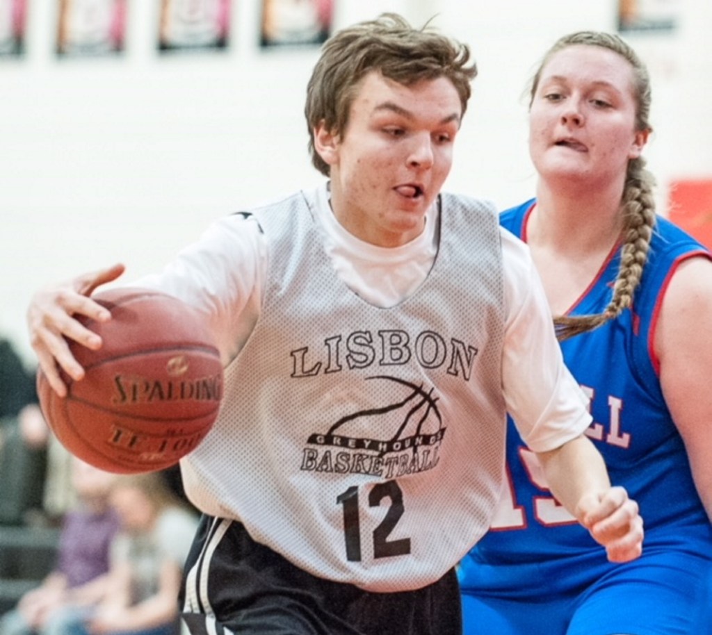 Lisbon's Nick Austin, left, dribbles up the court while being defended by Oak Hill's Alexis Harris during Tuesday's Unified basketball game in Lisbon.