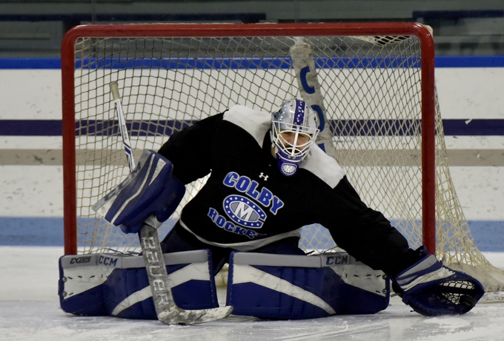 Colby goalie Sean Lawrence catches a puck in his gove during practice Tuesday in Waterville.