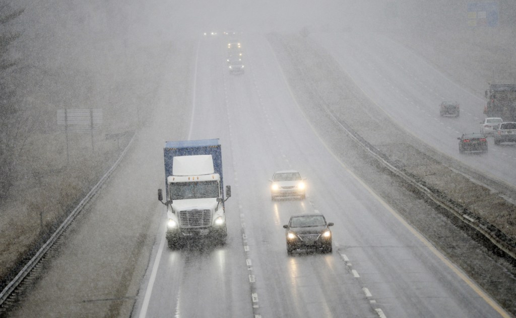 Vehicles make their way south on the Maine Turnpike as snow begins to fall Wednesday in Saco.