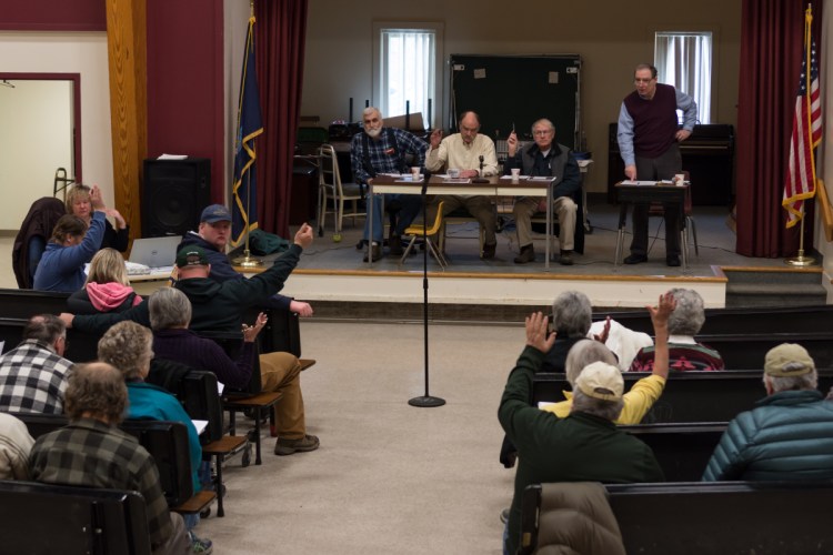 Starks residents vote by a show of hands Saturday morning to adopt a proposed "Local Food & Community Self Governance Ordinance" at Town Meeting in Starks.