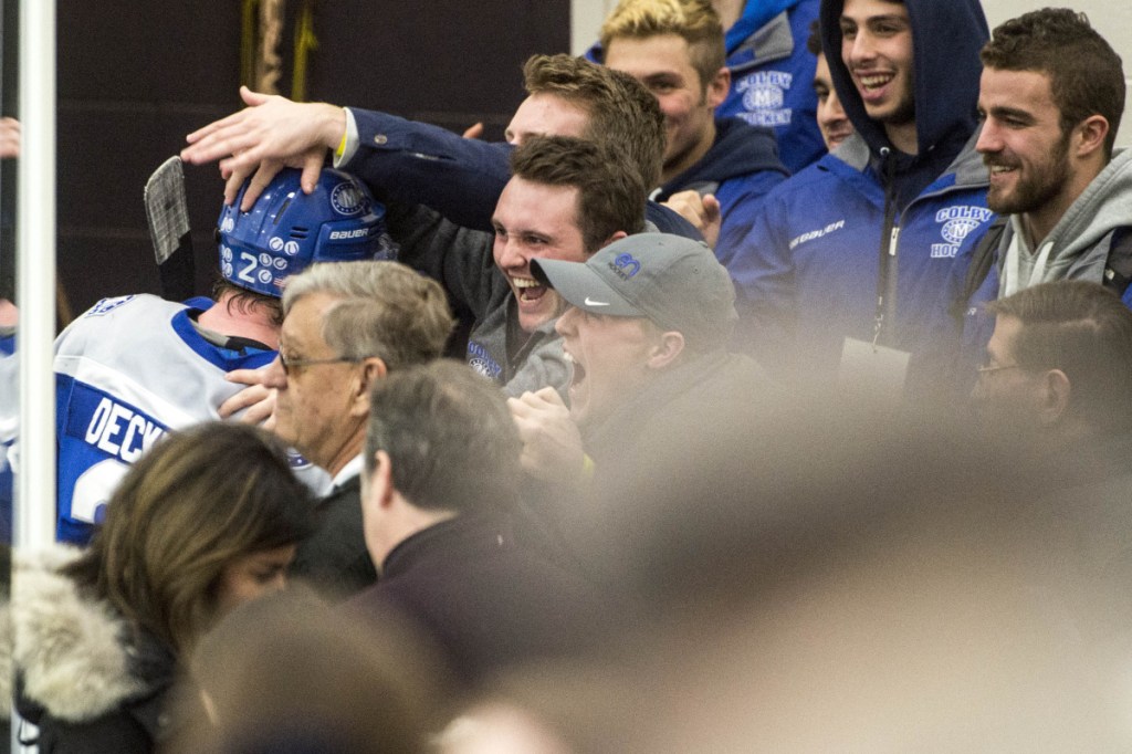 Colby College fans greet senior defenseman Michael Decker (2) the team leaves the ice at Harold Alfond Forum in Biddeford following the Mules' 4-2 win over the University of New England in the first round of the NCAA Division III hockey tournament Saturday night.