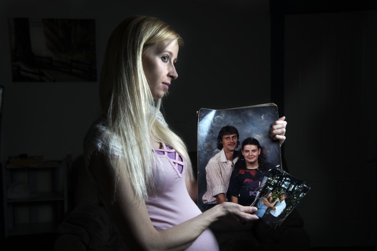 Harley Orchard holds a picture of her late father, Vaughan Orchard, and her mother, Tammy Orchard, when they were in their late 20s as she remembers him at her apartment on Spruce Street in Waterville on Thursday. Vaughan was a well-known homeless man who died of a heart attack. The family can not afford the funeral or cremation expenses and has started a GoFundMe page to raise funds.