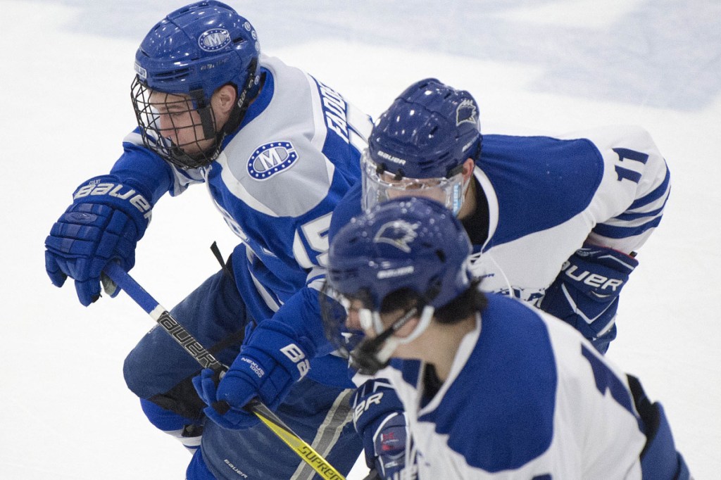 Colby College senior Griffin Fadden (15) battles for position with the University of New England's Tyler Seltenreich (11) during an NCAA tournament game last Saturday at the Harold Alfond Forum in Biddeford.