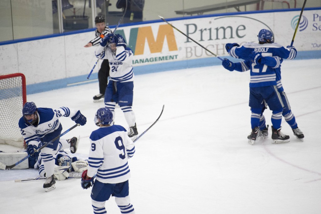 Colby forward Michael Rudolf, back right, celebrates his goal against University of New England in the second period of an NCAA Division III first round game last Saturday at the Alfond Forum in Biddeford.