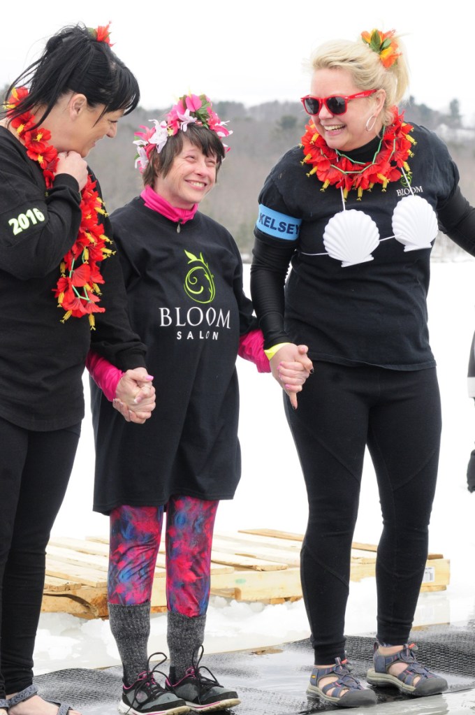 From left, Tricia Lynn Trial, Laura Lucas and Kimberly Stoneton get psyched up March 25, 2017, to jump into Maranacook Lake during last year's ice plunge at the Winthrop Town Beach.
