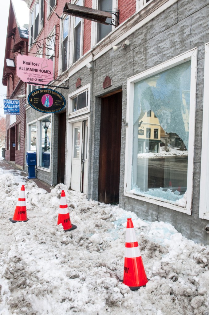 Damage to the window of unoccupied storefront at 106 Water St. is evident Thursday in downtown Hallowell. Earlier in the morning, a hit-and-run driver of a tractor-trailer failed to stop at intersection of Water and Winthrop streets, then struck a street light, which broke the window.