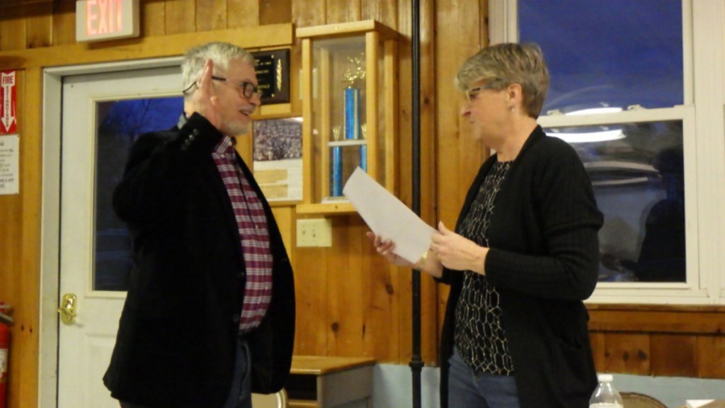 Moderator Tom Saviello, left, is sworn in Monday by Town Clerk Lou Brackett at the Temple Town Meeting.
