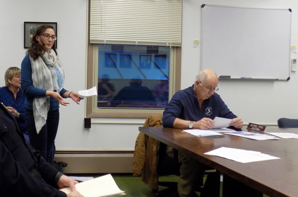 Mt. Blue High School senior River Lisius addresses the Farmington Board of Selectmen on Thursday night about using Meetinghouse Park for a student march. Selectman Michael Fogg is at right.