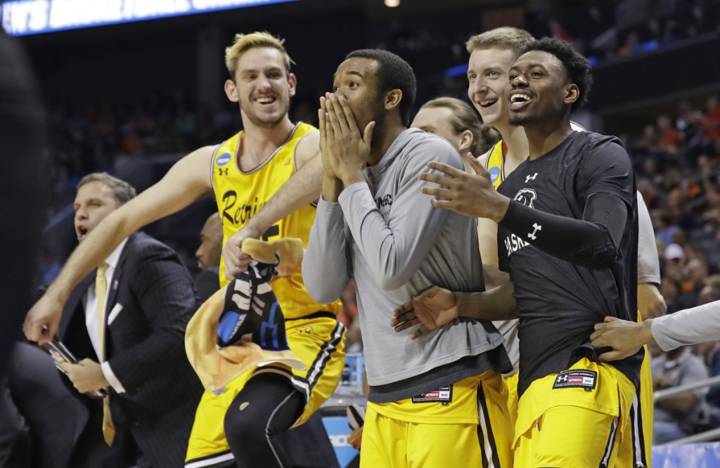 UMBC players celebrate a teammate's basket against Virginia during the second half of a first-round game in the NCAA tournament Friday night in Charlotte, North Carolina.