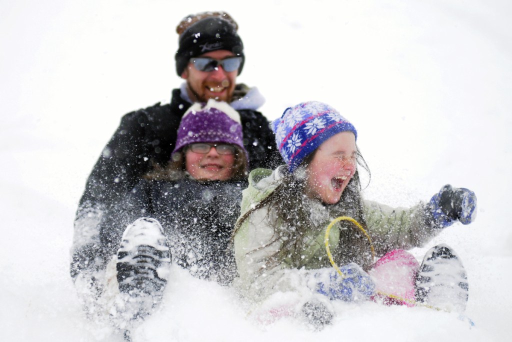 Kaelyn Brillant, 8, right, emits a howl March 21, 2016, while sliding with her sister, Jayden, 11, and father Scott at the Oaklands in Gardiner. The Brillants, of Richmond, were taking advantage of a spring snow storm and a canceled school day to take the plunge. "It's the last snow day," Scott Brillant said. "Or so I hope." There have been so many days of school canceled because of snow this year that Augusta students will be required to attend school for an additional hour a day, for 10 school days, to help make up for the missed days of school.