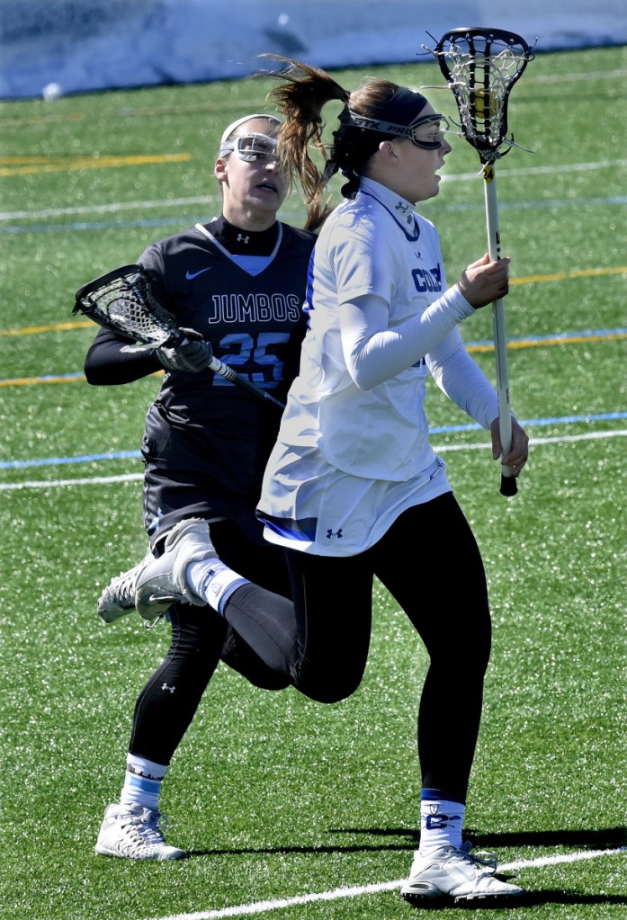 Colby's Merritt Davie takes the ball downfield as Caroline Nowak of Tufts pursues during a game Sunday in Waterville.