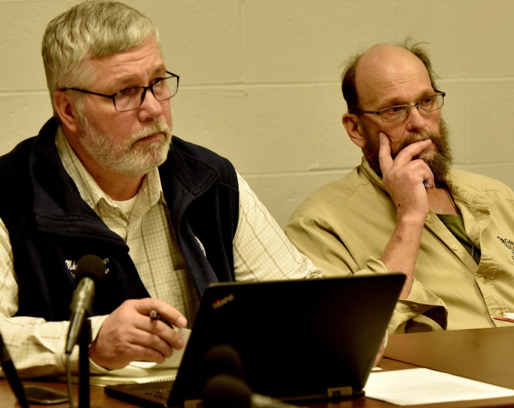 Winslow Town Manager Mike Heavener, left, and Council Chairman Steve Russell listen Monday to an AOS 92 budget presentation.