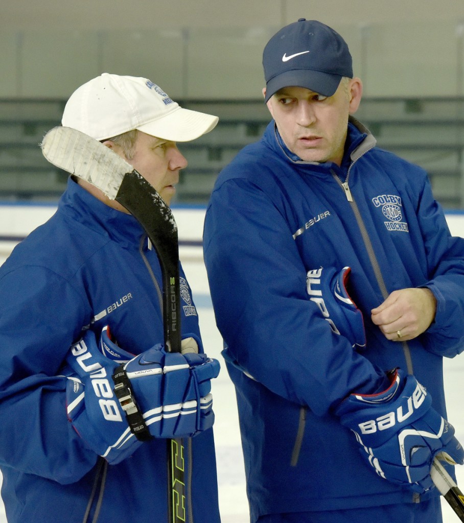 Colby College assistant hockey coach Mike Latendresse, right, confers with head coach Blaise MacDonald during practice Tuesday in Waterville.