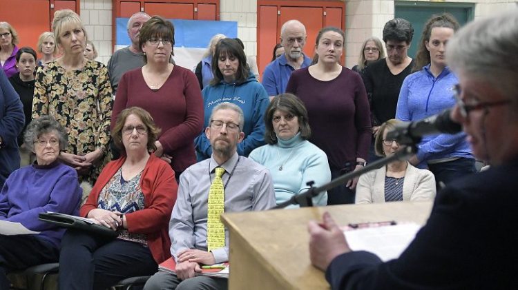 Winthrop school union leader Terry Buchanan addresses the school board Wednesday as teachers stand in solidarity with her during a meeting in Winthrop.