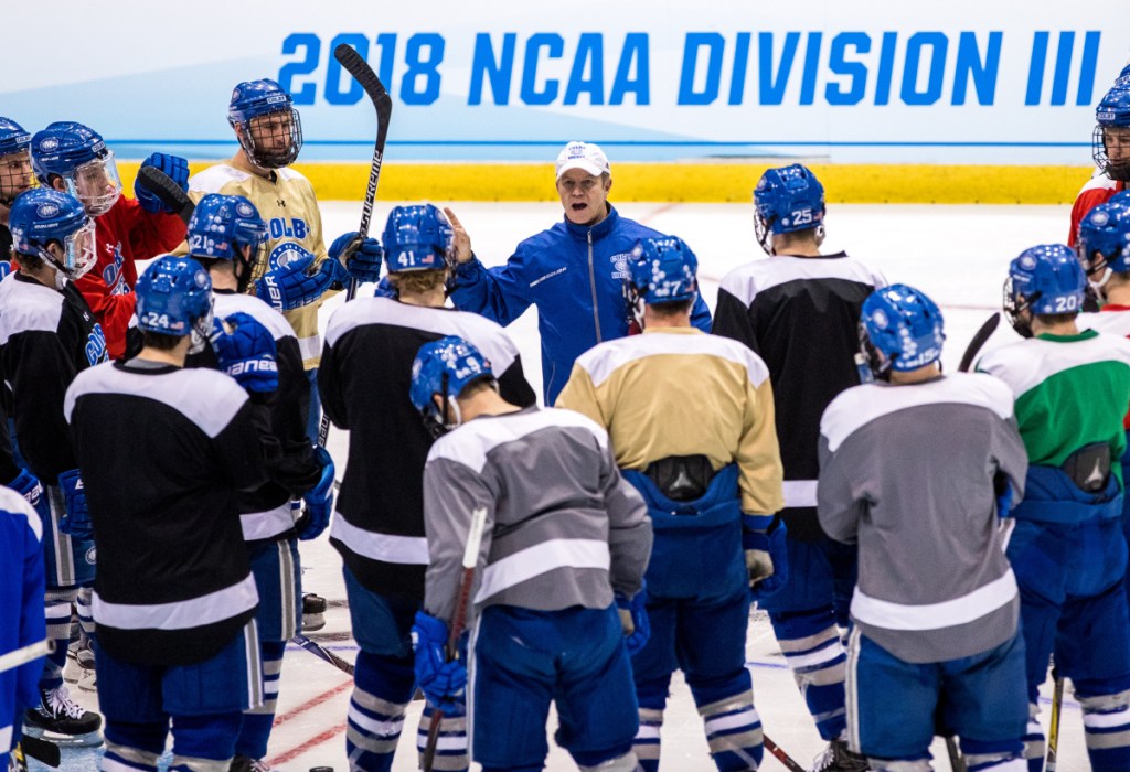 Colby men's hockey coach Blaise MacDonald, front left, talks to his team during practice Thursday afternoon at Herb Brooks Arena in Lake Placid, New York. The Mules will play St. Norbert College in an NCAA Division III Frozen Four game Friday at 6:30 p.m.