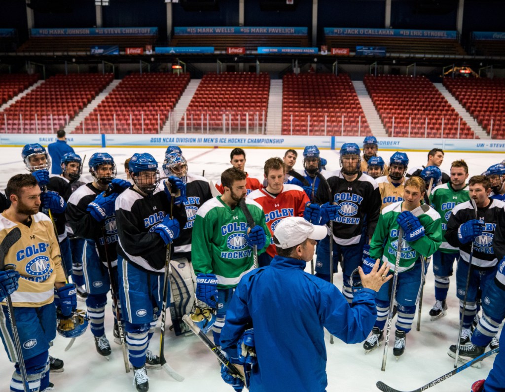 Colby men's hockey coach Blaise MacDonald, front left, talks to his team during practice Thursday afternoon at Herb Brooks Arena in Lake Placid, New York. The Mules will play St. Norbert College in an NCAA Division III Frozen Four game Friday at 6:30 p.m.
