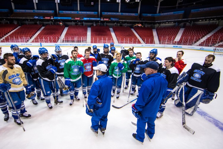 Colby men's hockey coach Blaise MacDonald, front left, talks to his team during practice Thursday afternoon at Herb Brooks Arena in Lake Placid, New York. The Mules will play St. Norbert College in an NCAA Division III Frozen Four game at 6:30 p.m. Friday. At right is assistant coach Mike Latendresse, a Winslow resident and former Messalonskee High School hockey coach.