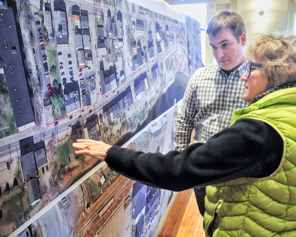 Dawn Gallagher, front, asks Cody Jean, project superintendent for Sargent Corp., a question during an open house Thursday in Hallowell City Hall about the upcoming Water Street construction project.