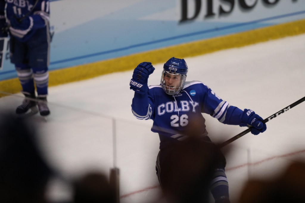 Contributed photo/Colby athletics 
 Colby J.P. Schuhlen celebrates after the Mules scored their first goal against St. Norbert College during a Division III Frozen Four game Friday in Lake Placid.
