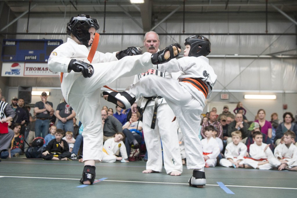 Staff photo by Michael G. Seamans 
 Dylan Lomas, left, and Vincent Young, right, spar at the Battle of Maine Martial Arts tournament Saturday at Thomas College in Waterville.