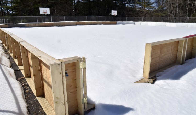 The relocated ice skating rink in Skowhegan is covered with snow Monday at the new location near the town recreation center. A group of locals is concerned with the new ice rink location after it was moved from the Skowhegan Fairgrounds.