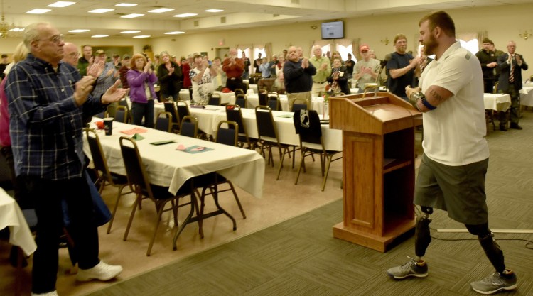Veterans advocate Travis Mills gets a standing ovation Thursday after speaking at a National Vietnam Veterans Day celebration in Waterville.