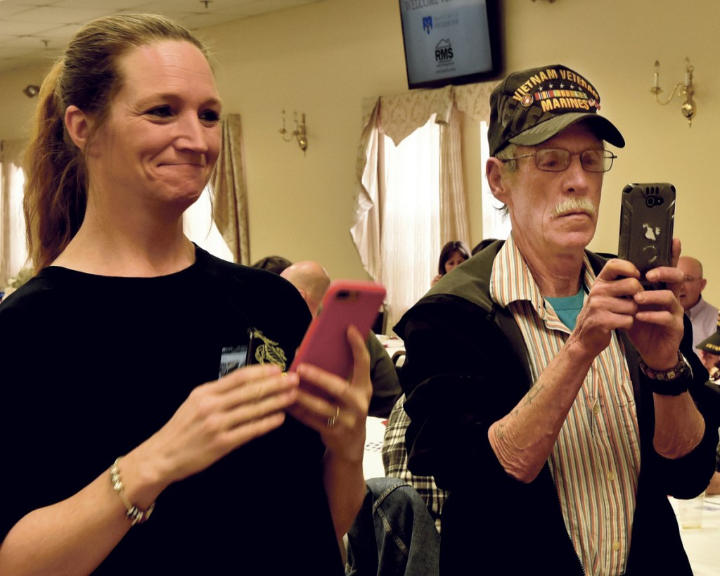 Veronica Fortier and Frank McAdoo photograph veterans advocate Travis Mills during a National Vietnam Veterans Day celebration Thursday in Waterville.