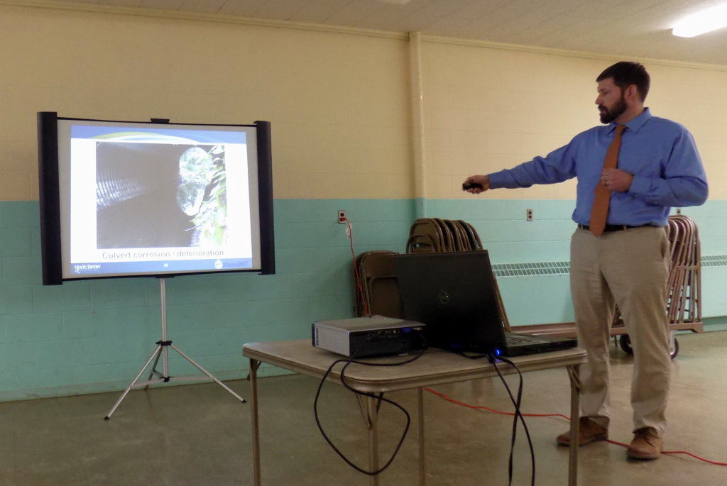 Project Manager Aron Lachance of Hoyle, Tanner & Associates of Portsmouth, New Hampshire, shows slides Thursday night of the deteriorated Dutch Gap Bridge in Chesterville. The company has designed a new bridge over Little Norridgewock Stream.