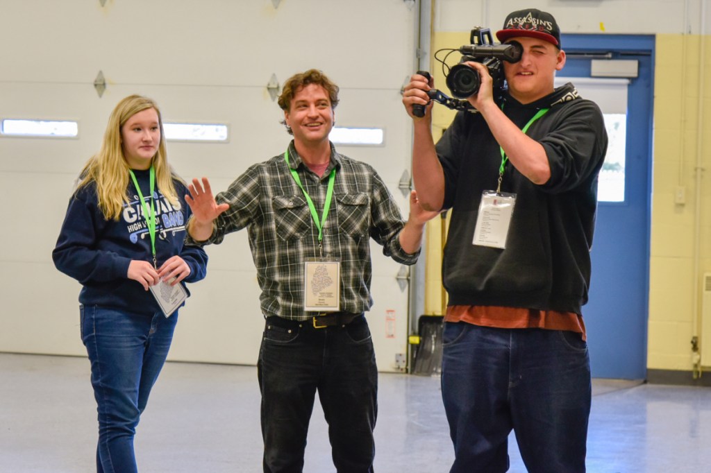 Filmmaker Brett Plymale, of Kennebunkport, center, coaches Randy Hubbard, right, 17, of Waterville, on Saturday in how to operate a camera. They are joined by Cassie Carr, 13, of Calais, at the Maine Student Film & Video Conference in Waterville.
