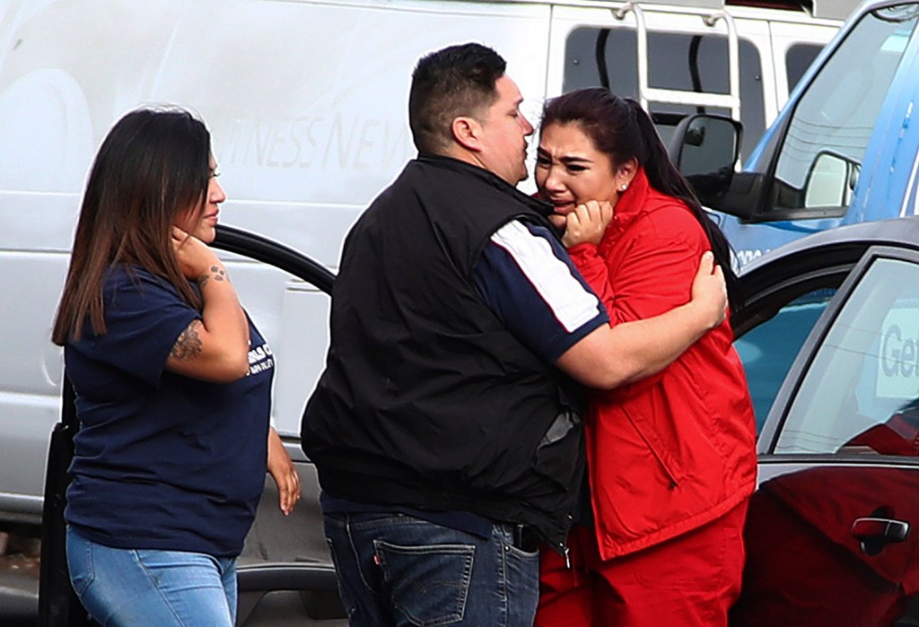 Fernando Juarez, center, embraces his sister Vanessa Flores at the Veterans Home of California on Friday. Flores, a caregiver at the facility, exchanged texts with family members while sheltering in place as a gunman took at least three people hostage at the largest veterans home in the United States.