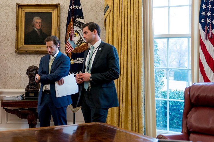 White House aide John McEntee, right, and Treasury Secretary Steve Mnuchin's Chief of Staff Eli Miller, stand in the Oval Office on Jan. 31. McEntee is leaving the White House and will rejoin Trump's campaign.