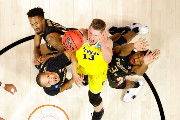 Michigan forward Moritz Wagner (13) shoots between Florida State's Braian Angola, upper left, CJ Walker, lower left, and Trent Forrest during the second half of an NCAA men's college basketball tournament regional final Saturday in Los Angeles. 