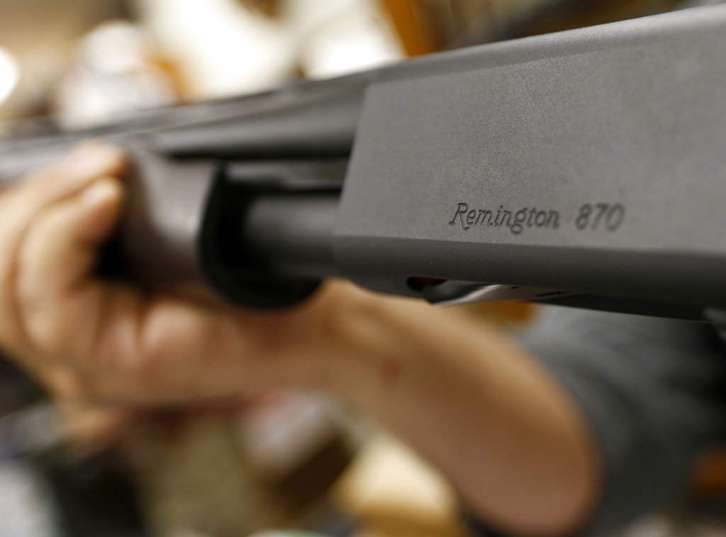 A customer hefts Remington's model 870 shotgun at Duke's Sport Shop in New Castle, Pa. The company has been making firearms since 1816.