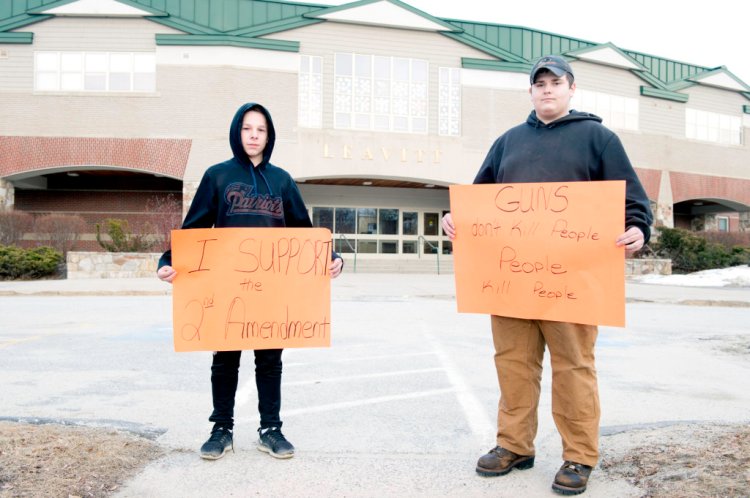 Freshman Brandon Spring, left, and junior Justin Lavigne held a counterprotest during a classroom walkout at Leavitt Area High School in Turner on March 21. The walkout was part of a nationwide event protesting gun violence in response to the school shooting in Parkland, Florida, where a gunman killed 17 students.