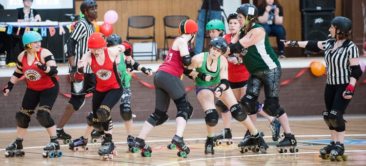 The Inferno's Queen Bootycca aka Erin Lynch, second from left, breaks away from the pack during the first bout of the night against Northwood Knockouts at the Lewiston Armory on Saturday. The Slam-i-versary roller derby double header was sponsored by the Androscoggin Fallen Angels Roller Derby League. 