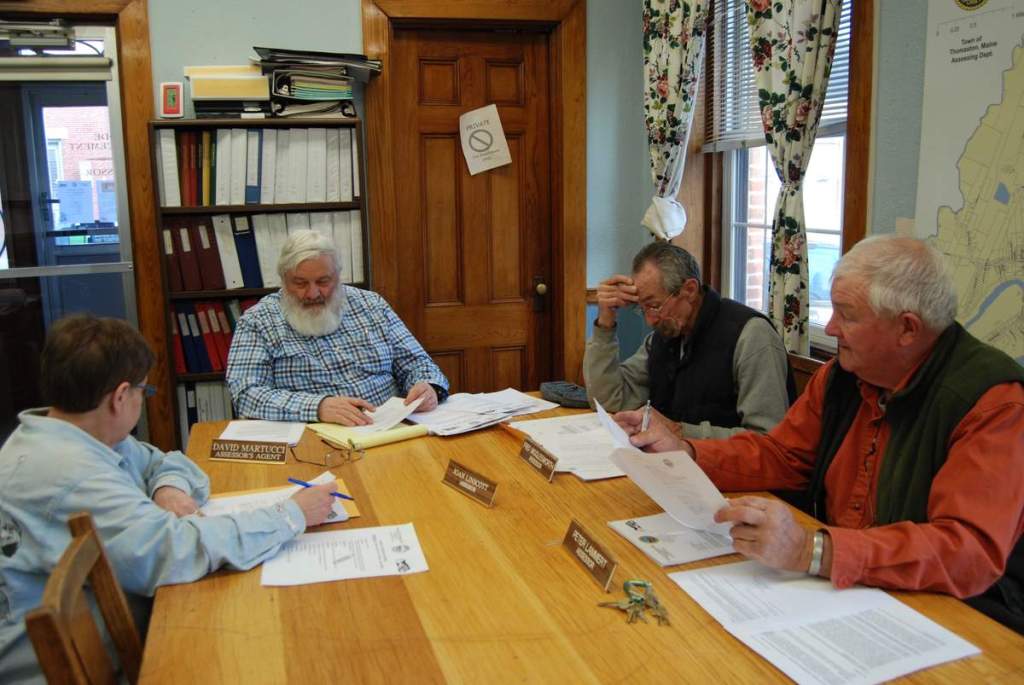 Members of the Thomaston Board of Assessors, from left, Joan Linscott, Assessor's Agent David Martucci, Fred Wigglesworth and Peter Lammert, review Walmart's application for a tax abatement on March 28. 