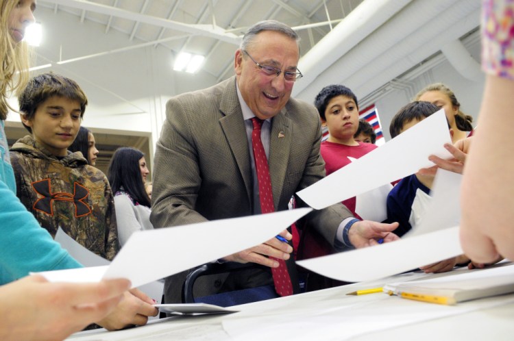 Gov. Paul LePage signs autographs for students Wednesday during the mock election event at the Augusta State Armory.