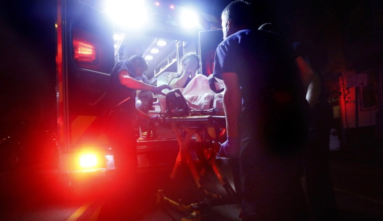 Portland paramedics use naloxone to revive a woman after a report of a heroin overdose on Congress Street in 2015. The number of overdose deaths is still on the rise in Maine, six years into the epidemic.