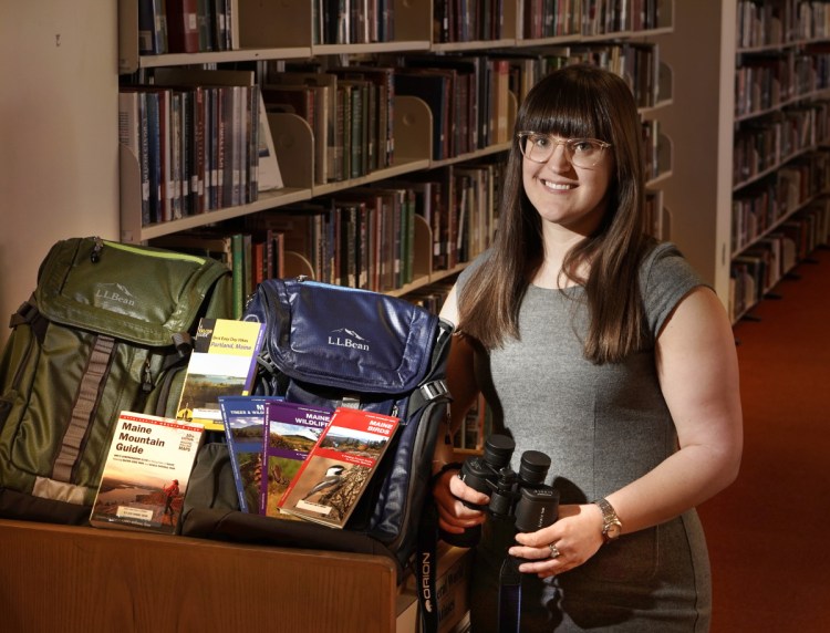 Meg Gray, science and technology librarian at the Portland Public Library, with backpacks that will be available to be checked out filled with items geared toward hiking, birding and stargazing. Gray is also saving seeds that library patrons will be able to check out.