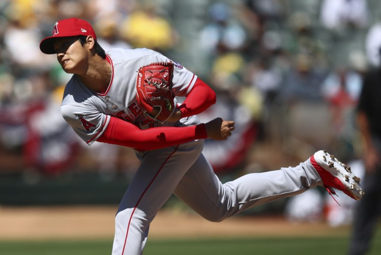 Shohei Ohtani of the Angels delivers a pitch Sunday in his first major league start on the mound, against the Athletics. Ohtani got the win, allowing three hits and three runs in six innings.