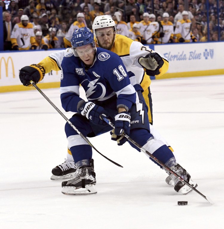 Ondrej Palat of the Tampa Bay Lightning tries to get away from Nashville defenseman Anthony Bitetto during the Predators' 4-1 win Sunday night.