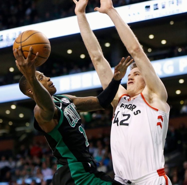 Boston Celtics' Terry Rozier (12) shoots against Toronto Raptors' Jakob Poeltl (42) during the first quarter of an NBA basketball game in Boston, Saturday, March 31, 2018. (AP Photo/Michael Dwyer)