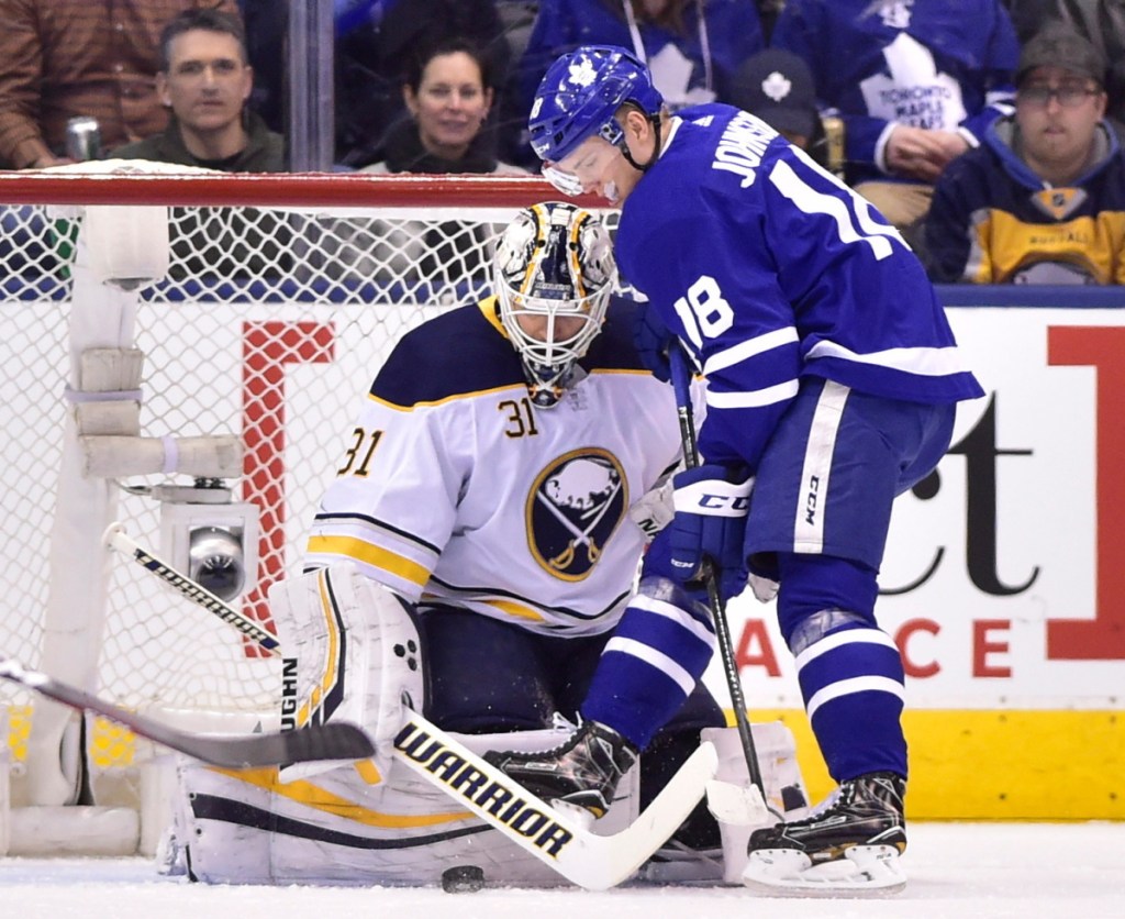 Buffalo Sabres goalie Chad Johnson makes a save against Andreas Johnsson of the Maple Leafs during Toronto's 5-2 win Monday night.