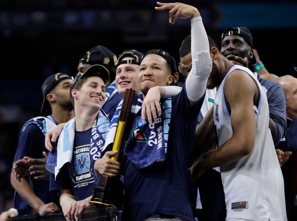 Villanova players celebrate after Monday night's title win over Michigan. The Wildcats won all six tournament games by double digits, last done by North Carolina in 2009.