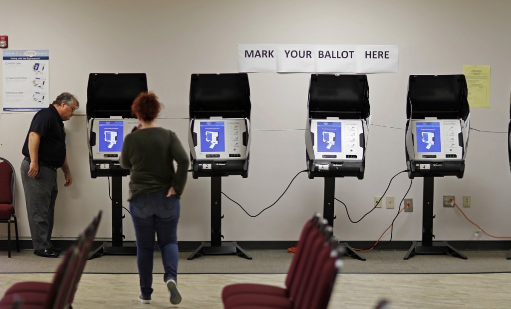 Technicians test voting machines in Conyers, Ga., in 2017. Congress allocated $380 million in March to help states update technology, but many remain at risk months before the midterms.