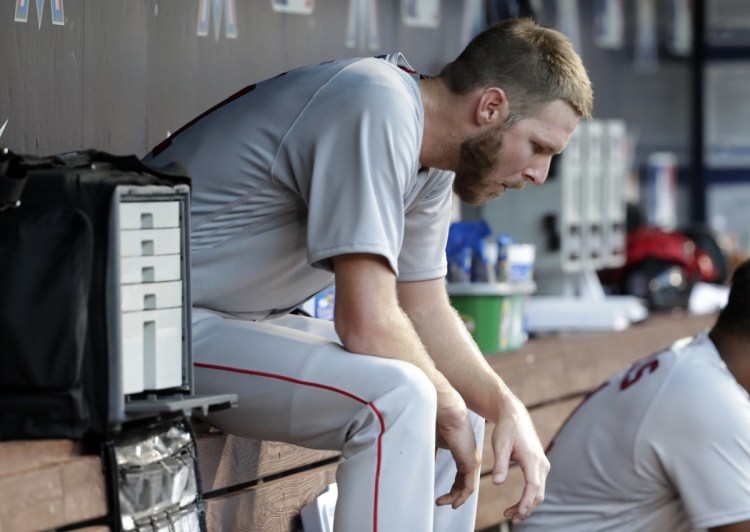 Red Sox starting pitcher Chris Sale sits in the dugout after the end of his outing Tuesday in Miami. Boston won 4-2 in 13 innings, leaving Sale without a decision despite allowing just one run in 11 innings over two starts so far this season.