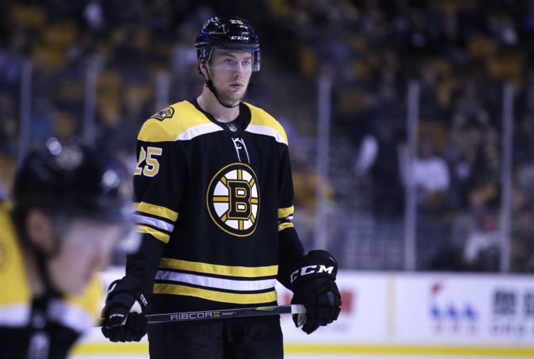 Boston Bruins defenseman Brandon Carlo will miss the rest of the season with a broken ankle.